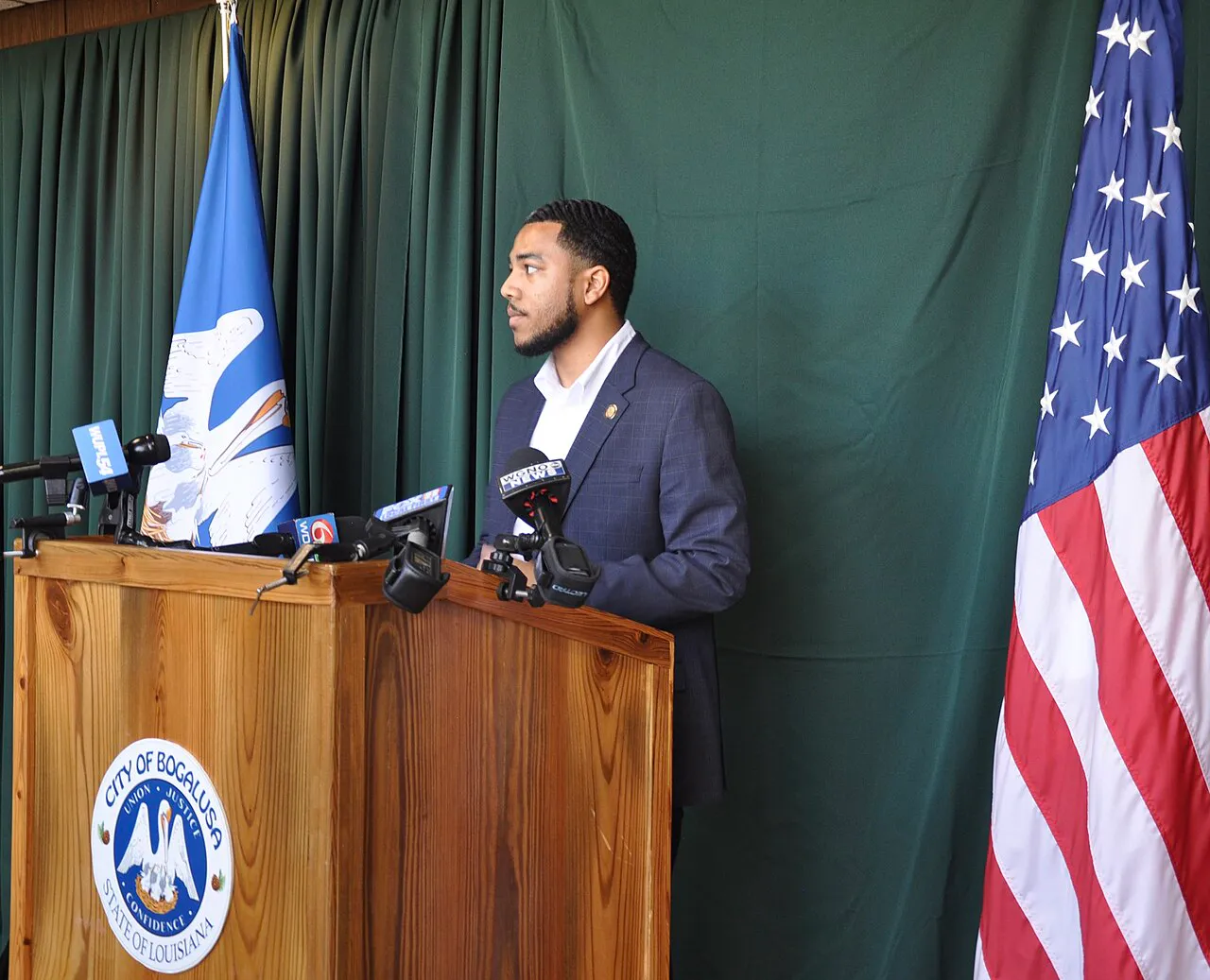 In this somber moment captured within the city hall, Mayor Tyrin Truong of Bogalusa addresses the media during a press conference. The conference was held in re