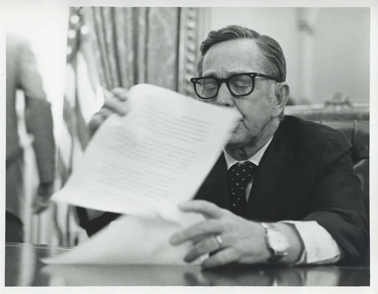 Carl Albert seated at his desk looking at some papers.
