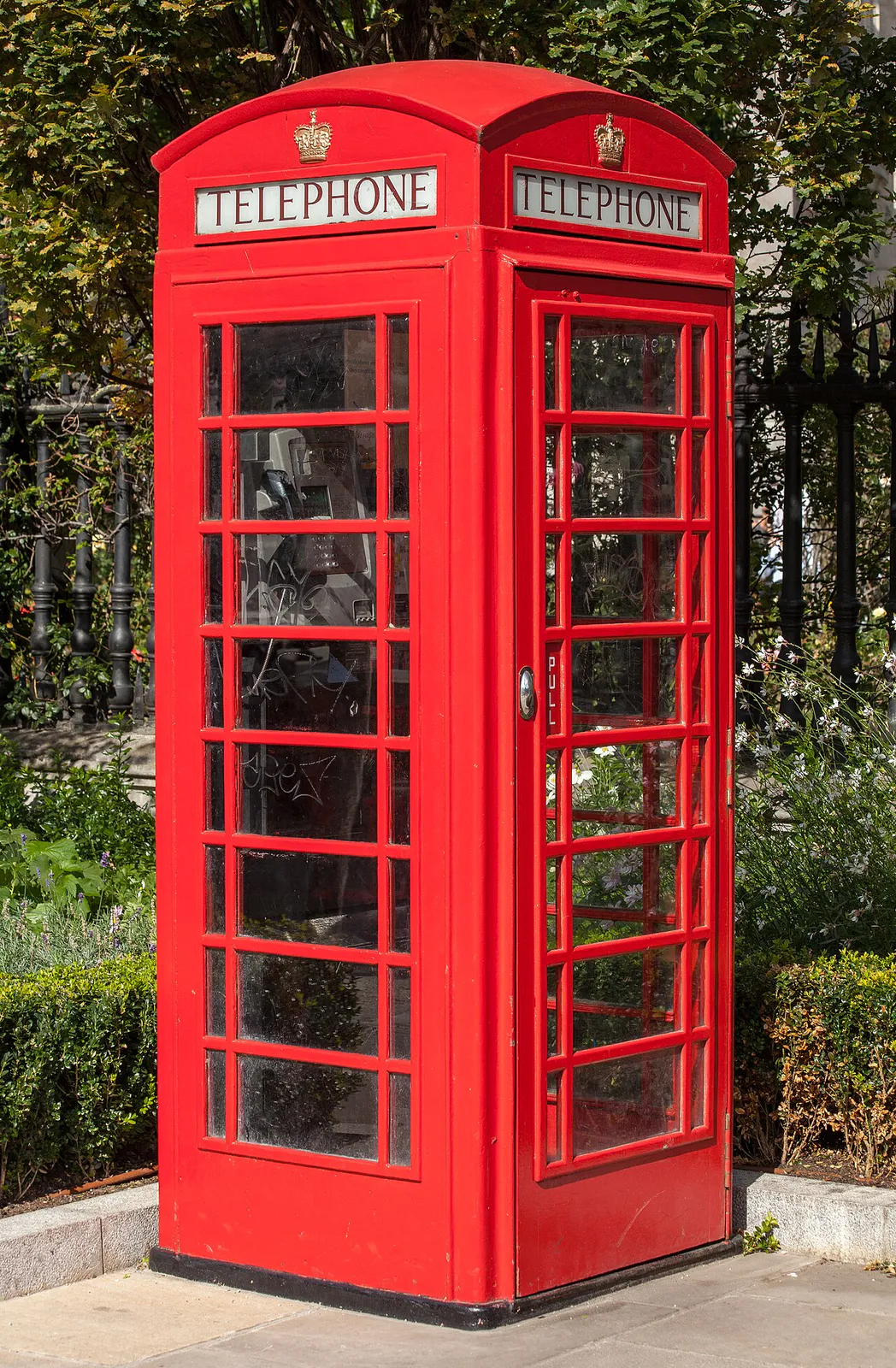 A red telephone box in front of St Paul's Cathedral , London, United Kingdom.