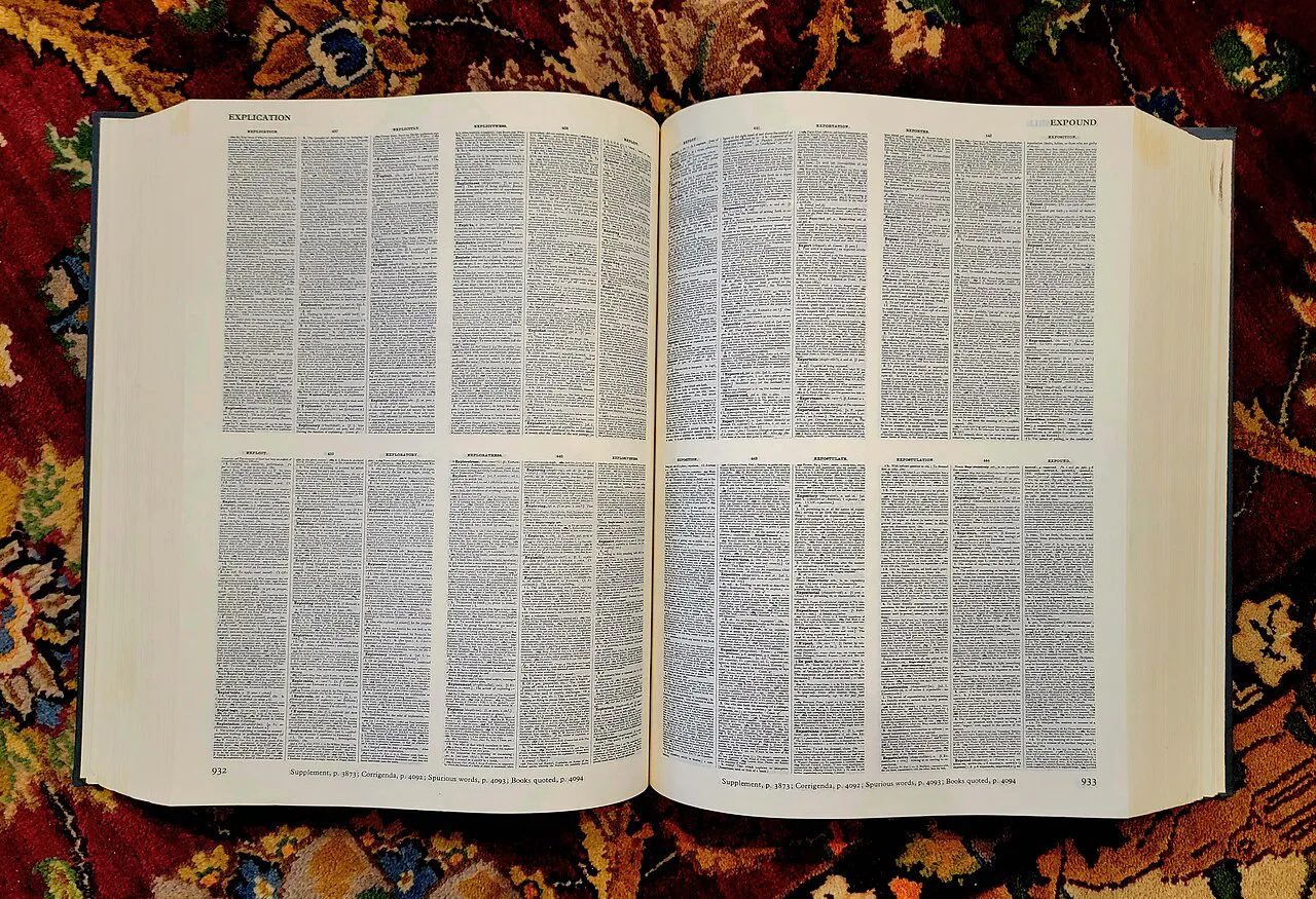 A view inside the Compact Oxford English Dictionary, showing how the content of four pages of the full sized edition are duplicated on one page. Photo by Jim He