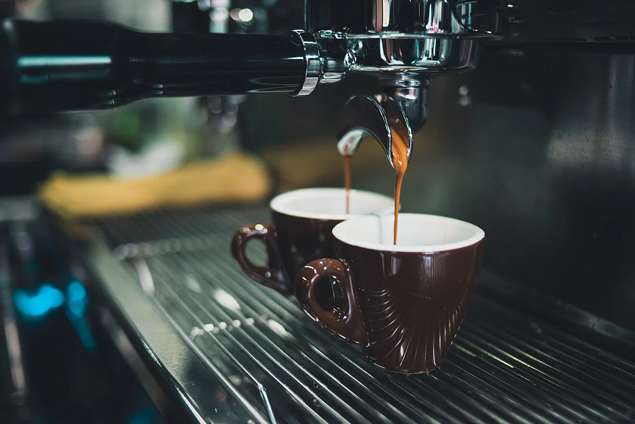 Close-up of Coffee Cups under an espresso machine