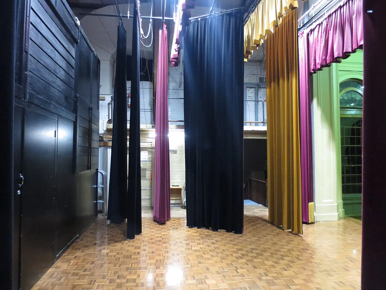 Stage at the Albert Hall in Canberra (20160 taken from stage right looking stage left. Stage curtains show pink black beige coloured curtains